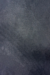 dark surface of stucco wall with traces of processing.