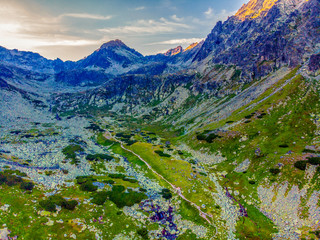 Beautiful waterfall flowing from top of a stone wall. Waterfalll Skok. Mlynicka valley with stone hiking trail. High Tatras mountains in Slovakia © Zedspider