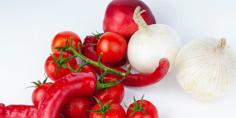  Lots of fresh ripe tomatoes,white onions and paprika with drops of dew. Close-up background with texture of red hearts with green tails. Fresh cherry tomatoes with green leaves.