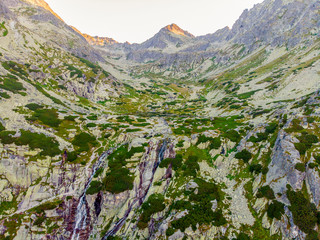 Beautiful waterfall flowing from top of a stone wall. Waterfalll Skok. Mlynicka valley with stone hiking trail. High Tatras mountains in Slovakia © Zedspider