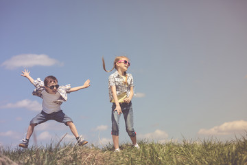 Brother and sister playing on the field