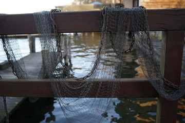 Close up of fishing net hanging at pier