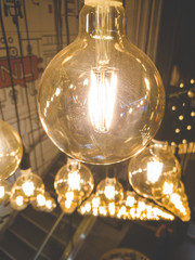 Fototapeta na wymiar Closeup toned image of beautiful decorative incandescent light bulbs glowing