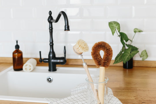 Plant Based Cleaning Brush Set Kitchen White Kitchen Background. Eco Friendly Kitchen, Zero Waste Home Concept