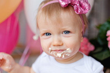 little girl with cake and balloons for her birthday