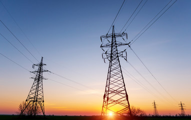 high-voltage power lines at sunset. electricity distribution station. high voltage electric transmission tower.