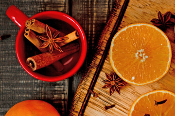 orange next to cinnamon on a dark background, romantic style, concept of winter evenings