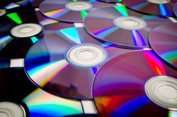 Background CD and DVD discs laid out on a flat surface. Background for saving information. Abstraction.