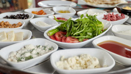 Тraditional turkish breakfast-cheese, olives, vegetables, yogurt, candied fruit, jam