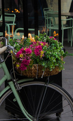 Fototapeta premium Romantic cityscape, bicycle, flowers and fire