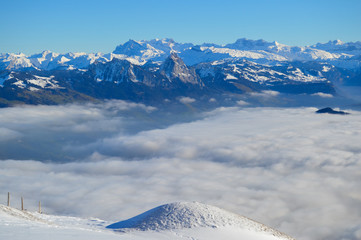 Fototapeta premium Snowy mountains with clouds