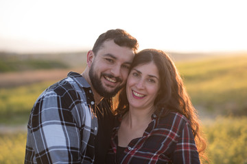 Couple in their thirties in spring outdoor image at sunset