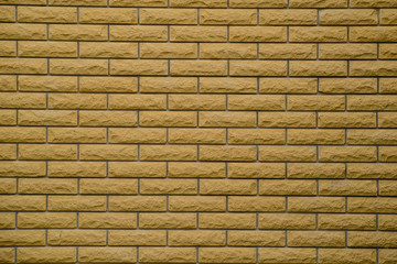 Texture of grungy yellow brick on the wall