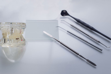 top view, medical dental instruments, on a sterile subject table of a dentist doctor. Near the dummy of human jaws and teeth. Medical Flatlay