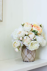 Pink and white peonies in a vase and a picture