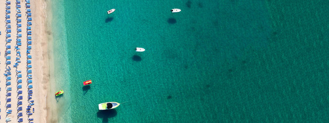 Aerial drone top down ultra wide photo of paradise organised sandy beach with emerald clear sea in Caribbean exotic destination