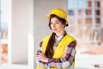 Portrait of young woman inspector at a construction site