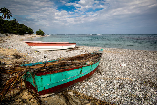 dramatic image of two fishing boats on the caribbean coast at Paraiso, dominican republic.