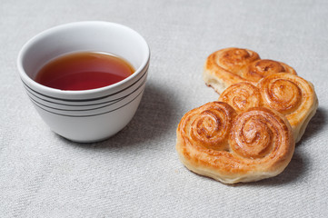 Tea mug and fresh pastries. Light morning breakfast. Fresh homemade cakes