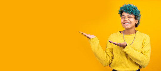 young girl or brunette woman with blue curls isolated on yellow background