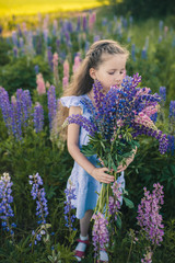 Cute girl in a field of purple flowers