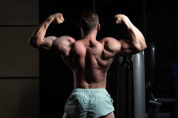 Muscular Men Is Hitting Rear Double Bicep Pose