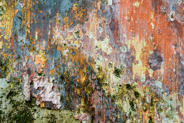 Close-up view of cracked paint layers on an old wall