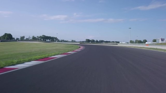 POV shot of car driving  on an empty racing circuit. Drone shot