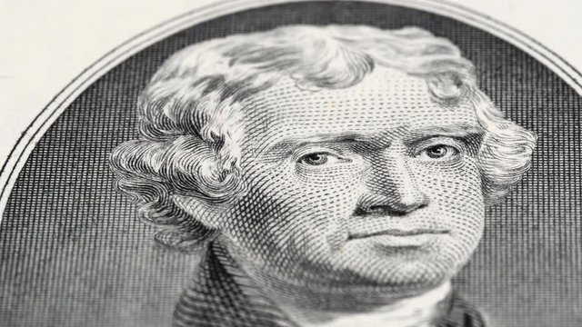 US President Thomas Jefferson on 2 dollar bill tracking, two USD. Low angle, macro. 4K