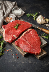 Raw beef steak with spices.