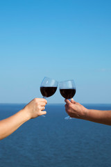 Two glasses of red wine at Dnipro river bay background, the clay mountains of Stanislav