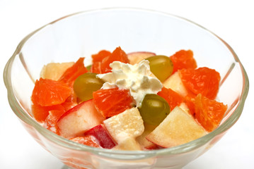 dessert of slices of apple, orange, grape and whipped cream
