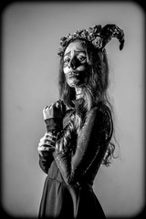 Halloween, black and white teneb portrait of a young woman dressed as a Mexican skull...