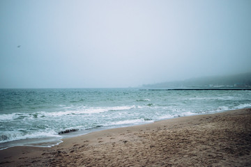 Sandy sea coast in city at evening
