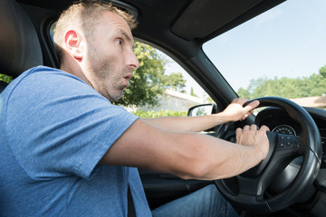 worried man using a horn in the car