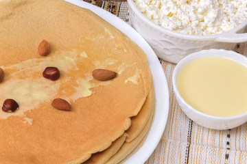 Homemade thin oat french crepes pancakes with fresh cottage cheese, cream sauce. Healthy eating concept, diet recipe rustic style breakfast or brunch