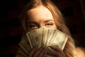 Close up beautiful very happy business womanwith US Dollar bills.