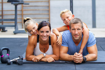 Happy family exercising in gym