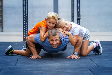 Happy family exercising together in gym - 324054190