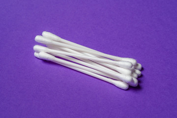 Close-up Heap of cotton stick hygienic cosmetic and healthcare accessory on a purple background
