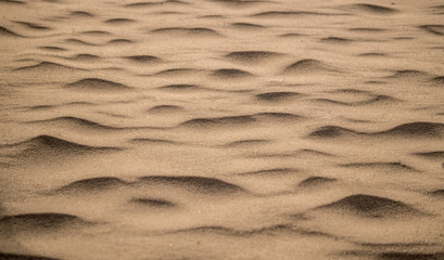 Fototapeta na wymiar Sand texture formed by the wind