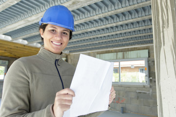 leasant attractive young architect holding plan