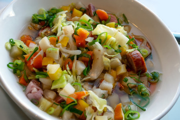stew with fresh organic vegetables and sausage in a white bowl