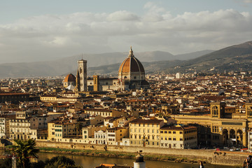 Fototapeta na wymiar Fantastic view of Florence in Italy with Arno River and the Cathedral with the big dome. Panorama of historical center of Florence from Piazzale Michelangelo. Panorama at Duomo.