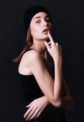 Obraz premium vogue fashion style female model posing in studio wearing trendy simple elegant black outfit 