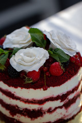 Red velvet cake with close up with white roses