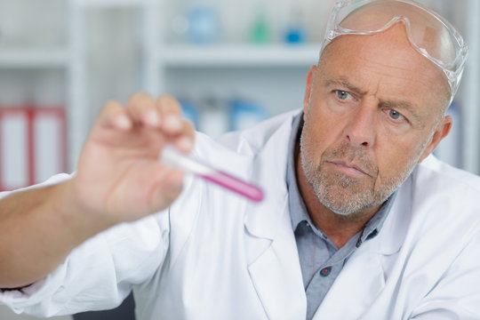 senior male researcher carrying out scientific research in a lab