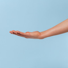 Female hand on a blue background in various positions.