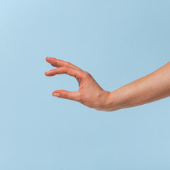 Female hand on a blue background in various positions.