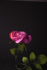 Pink silk rose with green stem